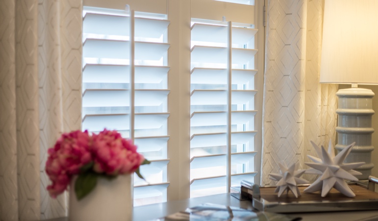 Plantation shutters by flowers in Fort Myers